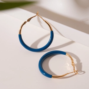 Minimalist blue enamel and gold hoop earrings with a modern C-shaped geometric design