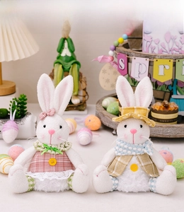 Detail showing a pair of plush Easter bunnies in pink and yellow plaid festive outfits