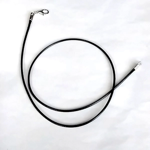 Detail of black waxed cord necklace with silver lobster clasp and extender chain
