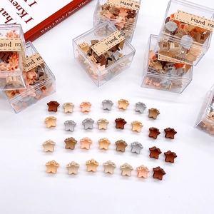Set of colorful star-shaped hair claw clips for girls in a small transparent display box