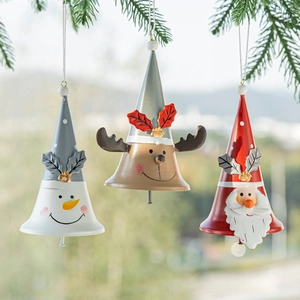 Christmas painted metal bells featuring Santa, Reindeer, and Snowman on a pine branch