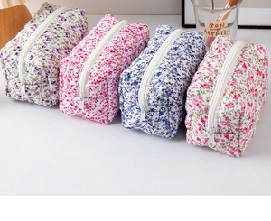 Floral print makeup bag set in blue, pink and purple with white zip closure and soft fabric