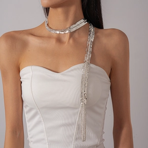 Detail of silver metallic mesh necklace with tassel drape on model for a luxury look