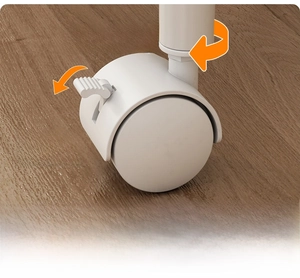 Close-up of 360-degree swivel caster with brake on wood floor for kitchen cart