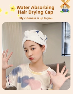 Detail of white microfiber hair towel with blue bunny ears and secure button closure