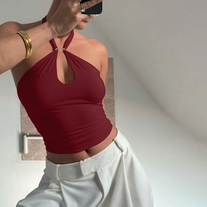 Detail view of the deep wine red knitted halter top featuring a stylish cutout design