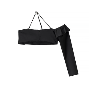 Detail of black one-shoulder cropped top featuring ruffle trim and side zipper closure