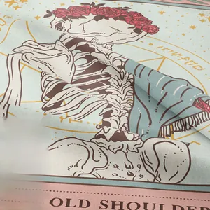 Close-up of bohemian skull tapestry fabric showing twill texture and rose print details