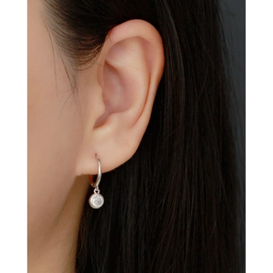 Close-up of S925 sterling silver hoop earrings with round bezel-set zircon stone