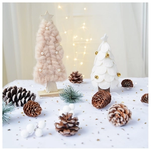 Detail of pink knitted and white felt mini Christmas trees with wood bases and pine cones
