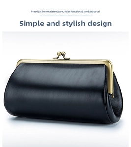 Detail shot of black genuine leather evening clutch with vintage bronze metal clasp closure