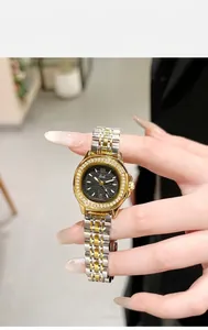 Detail of luxury Gedi watch with diamond bezel, black dial and two-tone steel strap