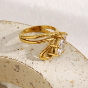 Macro view of 18K gold plated double layer ring featuring a marquise-cut clear gemstone