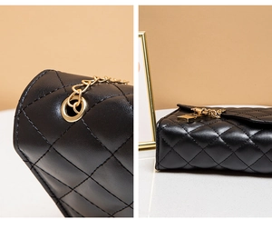 Detail of black quilted leather texture with gold metal chain link and secure buckle closure