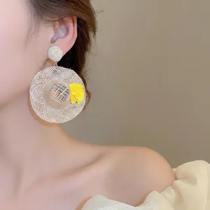 Miniature raffia straw hat earrings with yellow flowers for seaside vacation style
