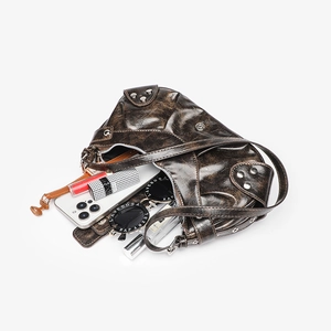 Detail view of the deep brown crocodile pattern handbag interior with phone and sunglasses