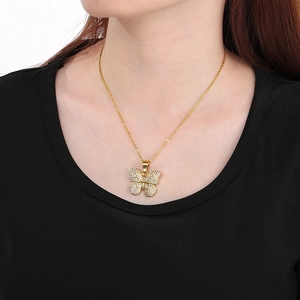 Elegant gold butterfly pendant necklace with shimmering crystals worn by a model