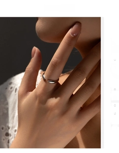 Close-up of minimalist S925 sterling silver open ring with teardrop ends on hand