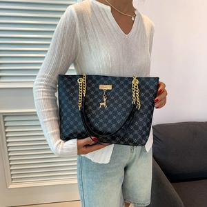 Minimalist chain shoulder bag with geometric texture and gold deer pendant detail