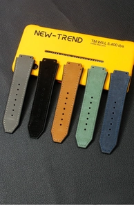 Detail of multi-color leather watch straps with precision stitching and custom lugs