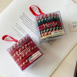 Christmas elastic hair tie set with woven red gold and green patterns in clear gift boxes