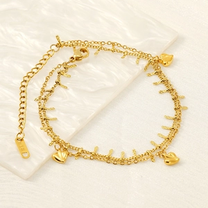 Detail of 18K gold-plated double-layer heart anklet with K18 stamp on a white plate