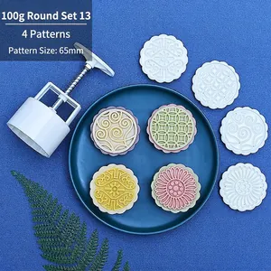 Close-up of 100g mooncake mold set with four 65mm circular floral pattern stamps