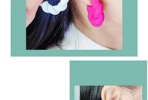 Detailed close-up of woven twist C-shaped earrings in matte white and rose pink colors