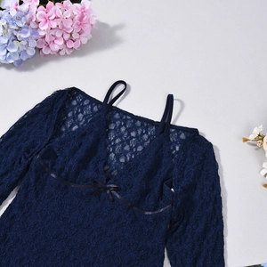 Detail of navy blue lace dress with delicate spaghetti straps and bow decoration