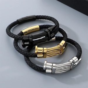 Close-up of three men's punk braided leather bracelets with steel nail head clasps.