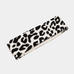 Close-up of knit leopard print headband showing black and white texture and fabric detail