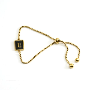 Detail of gold box chain bracelet with letter E square pendant and adjustable slider