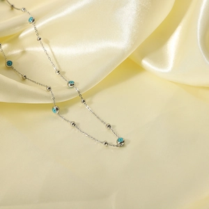18K silver-plated stainless steel necklace with blue evil eye beads on satin cloth