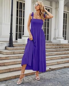 Detail of purple tiered maxi dress featuring bow shoulder straps and pleated bust detail