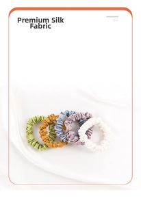Detailed view of five multi-colored 22mm silk scrunchies with heavy silk fabric texture