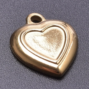Macro shot of gold-plated stainless steel heart pendant with textured finish