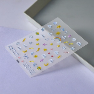 Detail of 5D embossed nail stickers featuring sun, moon, and clouds with pearlescent finish