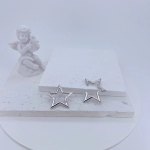 Macro view of silver star shaped necklace connectors with micro paved stones