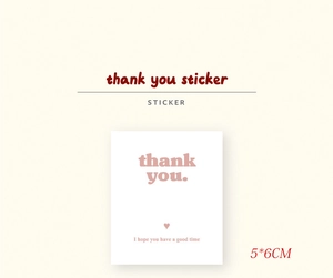 Macro shot of 5x6cm rectangular red-brown thank you stickers for gift packaging