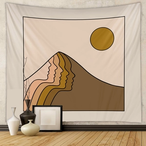 Detail of minimalist abstract tapestry with warm earth tones and sun hanging on gray wall