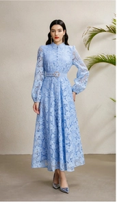 Detail of elegant lace dress featuring a stand collar, lantern sleeves and matching waist belt