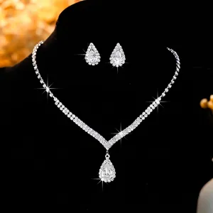 Macro detail of silver-tone teardrop zircon necklace and earrings bridal jewelry set
