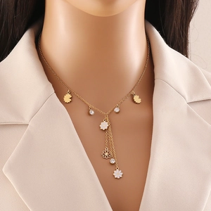 Elegant gold Y-shaped flower necklace with daisy pendant and long tassel on a model