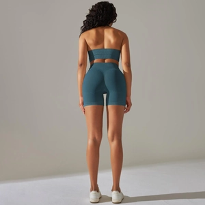 Detail view of teal seamless ribbed fabric on high-waisted yoga set with backless design