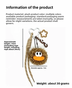 Detail view of brown plush cartoon doll keychain with woven rope and metal heart clasp