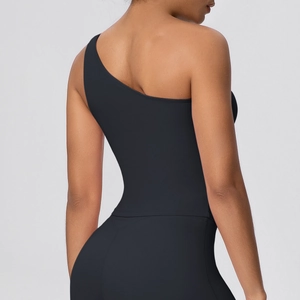 Detail view of the back of a black one-shoulder sports bra with seamless moisture-wicking fabric