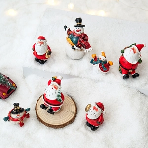 Miniature Christmas resin figurines set featuring Santa Claus and snowman on snow scene