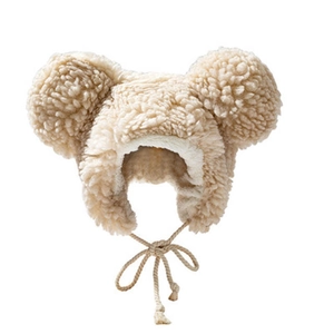 Cute beige plush earflap hat for kids featuring round ears and warm braided straps