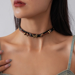 Double-layered leather choker with butterfly pendant in vintage bronze on model's neck
