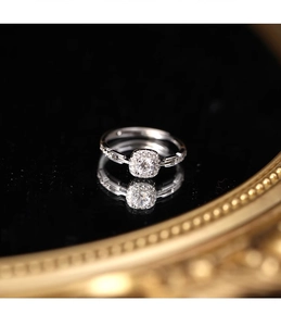 Close-up of sparkling square diamond silver chain ring with fine intricate settings